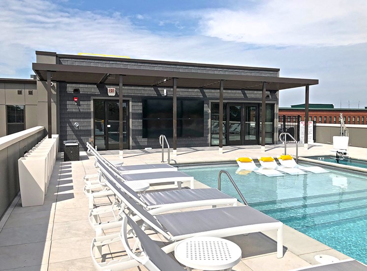 The rooftop pool, equipped with bathing chairs and lounge chairs.